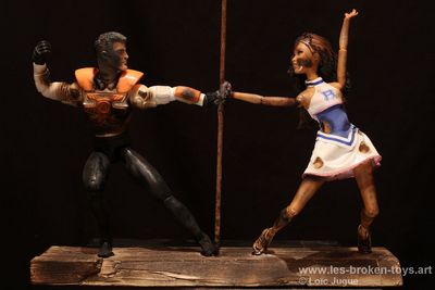 N°84: Let's Dance 
						Création 2026
						Dimensions: 40X39X12 cm. 
						Auteur; Loïc Jugue
						Technique : Deux poupées brûlées, homme et femme, dansent autour d'une barre de métal rouillée. 
						Elles sont collées  sur  socle en planche de chantier. 